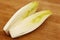 Freshly cut chicory halves on a cutting board