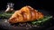 Freshly Cut Croissant With Rosemary On Dark Stone Background