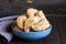 Freshly fried hand pies with meat in a bowl on a wooden background. Close up