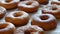 Freshly fried large round donuts on the table in the home kitchen. Donuts without glaze and powder