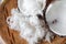 Freshly grated coconut and coconut shell on bamboo tray