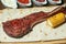 Freshly grilled Tomahawk steaks on wooden cutting board with corn