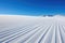 freshly groomed ski slopes against a cloudless sky