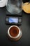 Freshly ground coffee in a manual coffee grinder container top view. Electronic scales with timer