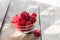 Freshly harvested raspberries in a glass bowl