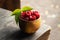 Freshly harvested raspberry. Raspberries on wooden table close up, wooden cup with berries