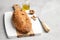 Freshly healthy bread with walnuts and raisins on cutting board on gray stone background.