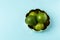 Freshly lime fruits on trendy light blue background