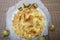 Freshly made hot cheese pie in a home kitchen framed with chestnuts around a dish - top view.