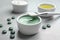 Freshly made spirulina in bowl,  and brush on light grey table