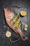 Freshly marinated raw Red snapper fish with lemon slices, garlic