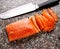 Freshly marinated salmon Carpaccio sliced on granite marble cutting board