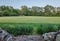 Freshly mown field in the summer and a trail from stairs