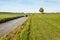 Freshly mown grassland bordering on a ditch