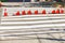 A freshly painted striped pedestrian crossing across the road is fenced off with traffic cones