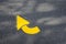 Freshly painted yellow arrows on asphalt for driving directions