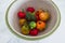 Freshly picked bell peppers and tomatoes of different colors in fruit bow, simple ingredients concept