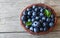 Freshly picked blueberries in a basket on old wooden background.Fresh organic blueberry.Bilberries.Healthy eating,vegan diet or ra