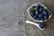 Freshly picked blueberries in a white bowl on old wooden background.Fresh organic blueberry. Bilberries.