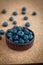 Freshly picked blueberries in woven natural screw pine leaf bowl.