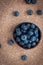 Freshly picked blueberries in woven natural screw pine leaf bowl.