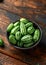 Freshly picked Cucamelon in rustic bowl on wooden table