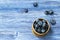 Freshly picked juicy and fresh blueberries in a Russian birch tree bark bowl on rustic vintage table. Bilberry top view
