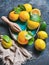 Freshly picked lemons with wet leaves in blue ceramic plate