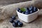 Freshly picked organic blueberries in a white heart shaped bowl on wooden background.Blueberry.Bilberries.