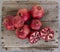 Freshly picked pomegranates displayed on weathered wood