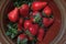 Freshly picked summer strawberries in a rustic bowl