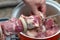 Freshly pickled meat sliced into barbecue man strung his hand on a skewer in the garden