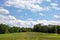 Freshly Planted Crop Rows Lead to Clouds, Blue Sky and Copy Space