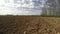 Freshly plowed farmland field in early spring, time lapse 4K