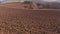 Freshly plowed field filmed backwards at a low angle