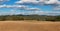 Freshly plowed field. Panorama of agricultural landscape. Autumn in agriculture. Blue sky and brown field.