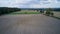 Freshly plowed field with rich, dark soil stretching out before a majestic forest backdrop