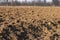 Freshly plowed land. A brownish relief texture. Loose soil for planting. Agriculture. Agricultural business. Technology of food