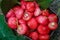 Freshly plucked rose apple fruit on basket for sale. Also known as jambu air Merah (Syzygium aqueum)