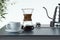 Freshly prepared black coffee in chemex pour over coffee maker near white coffee cup. 3d rendering