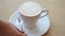 Freshly prepared coffee latte in cup, barista puts spoon