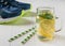 A freshly prepared drink made of lemon and mint on the background of sneakers wooden floor.