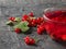 Freshly prepared drink of red currant berries on a dark wooden table.