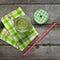 Freshly prepared green smoothie on old wooden table.