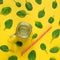 Freshly prepared green smoothie on yellow background