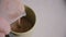 Freshly prepared milkshake is poured into faience cup on table