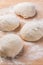 Freshly prepared yeast dough for pizza or bread on wooden background.