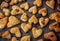 Freshly puff dough heart shaped cookies, top view close up. St Valentine`s Day concept. Abstract bakery background with copy space