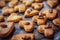 Freshly puff dough heart shaped cookies, top view close up. St Valentine`s Day concept. Abstract bakery background with copy space