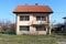 Freshly renovated suburban family house with new facade and roof and windows with closed window blinds